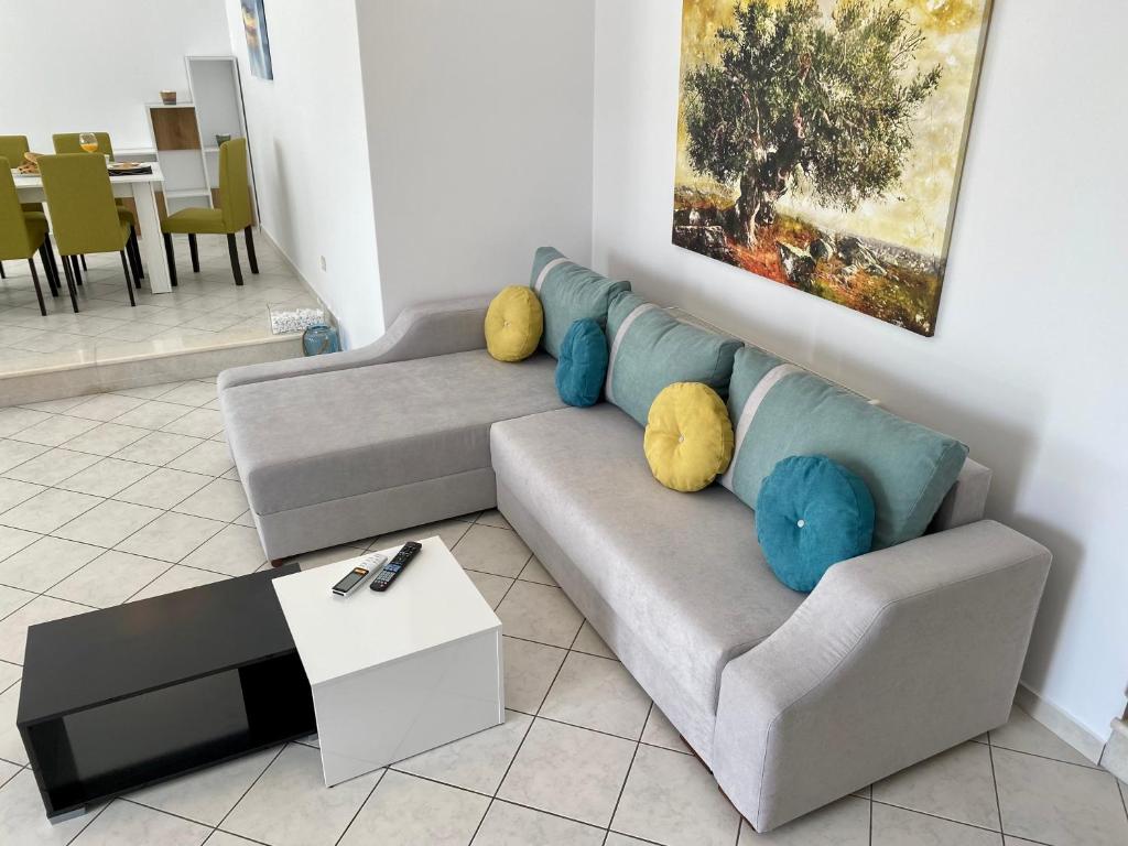 a living room with a couch and a table at PORTA HOME modern and hospitable in Naxos Chora