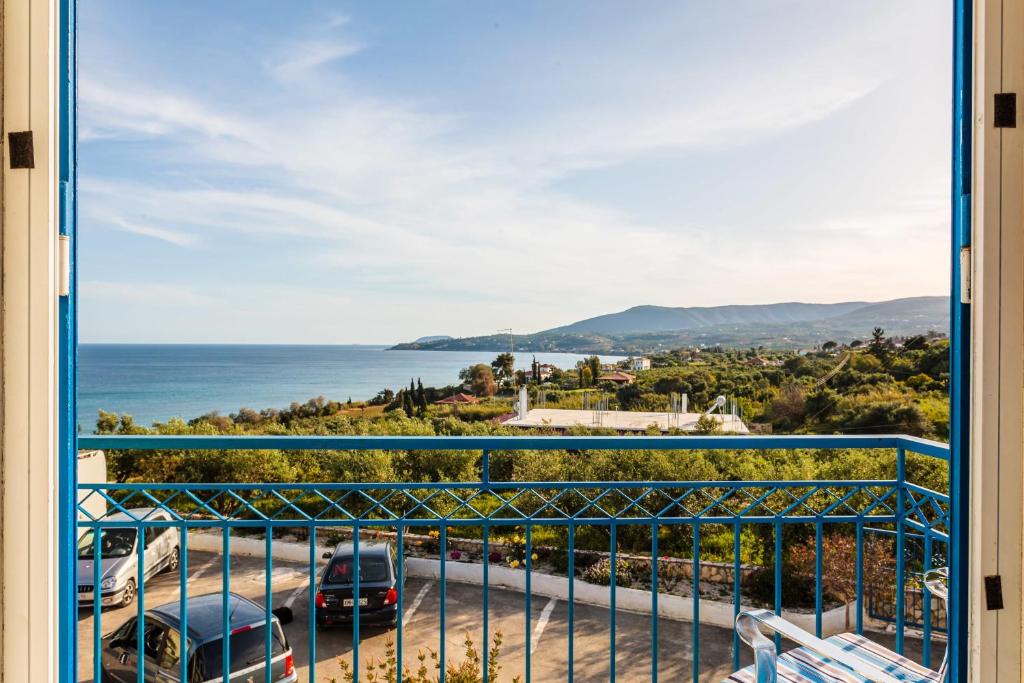 a view of the ocean from a balcony at Koroni Seaview Retreats - Summer Escape Lodgings in Koroni