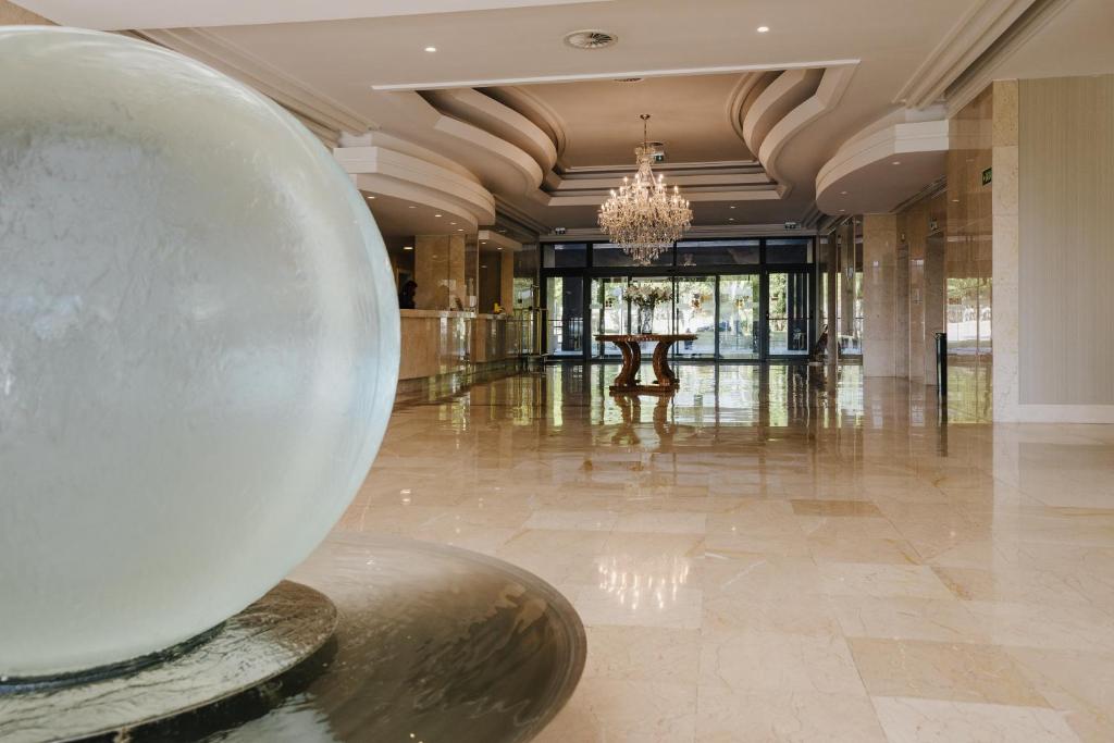 a large lobby with a large metal ball on the floor at Hotel Premium Chaves - Aquae Flaviae in Chaves