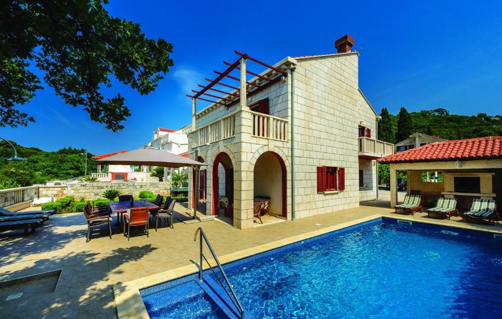 a house with a swimming pool in front of a house at Villa Anka in Zaton