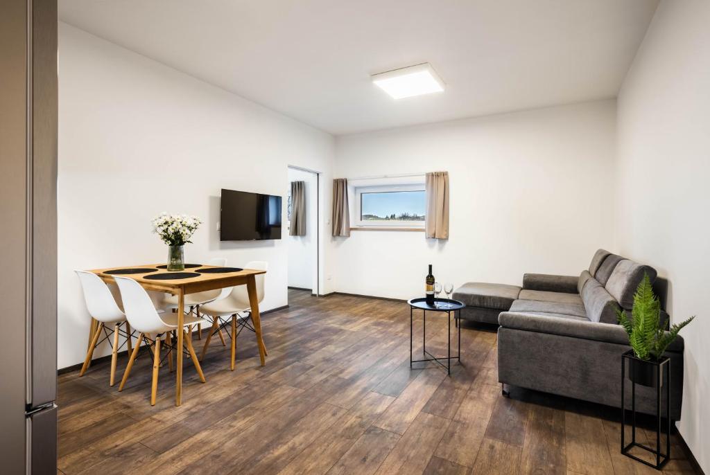 a living room with a couch and a table at Apartmány Panelka Costa Plana Lipno in Černá v Pošumaví