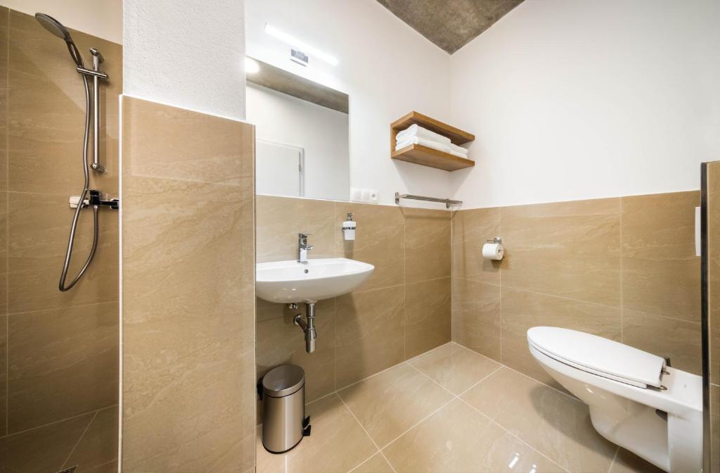 a bathroom with a toilet and a sink at Apartmány Panelka Costa Plana Lipno in Černá v Pošumaví
