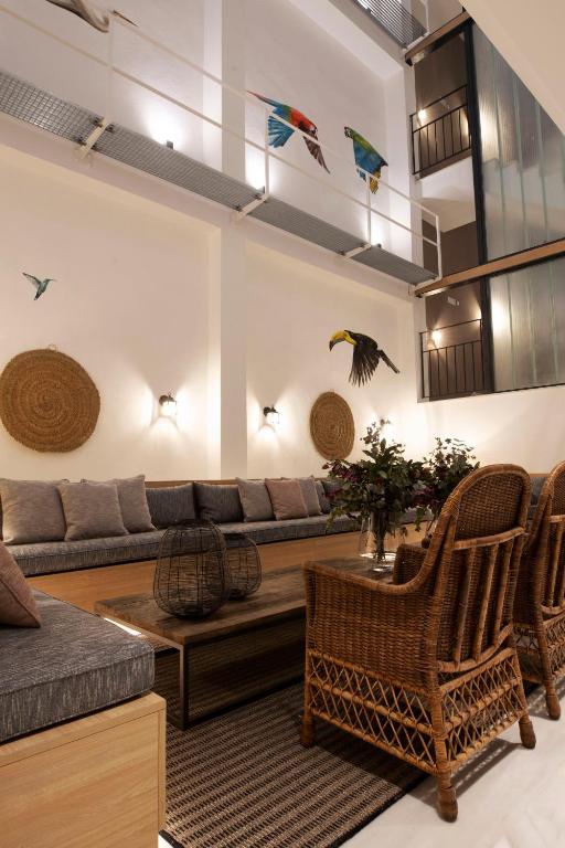 a living room with a couch and a table and chairs at Goodnight Cádiz Apartments in Cádiz