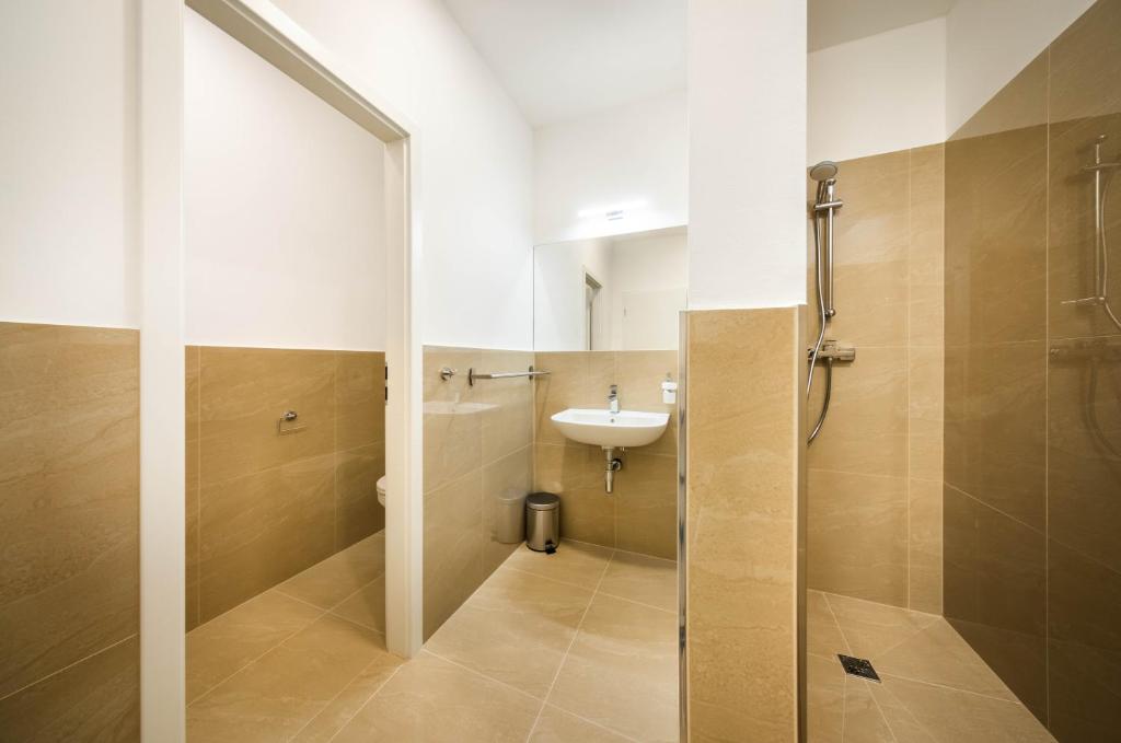 a bathroom with a sink and a toilet and a shower at Apartmány Panelka Costa Plana Lipno in Černá v Pošumaví