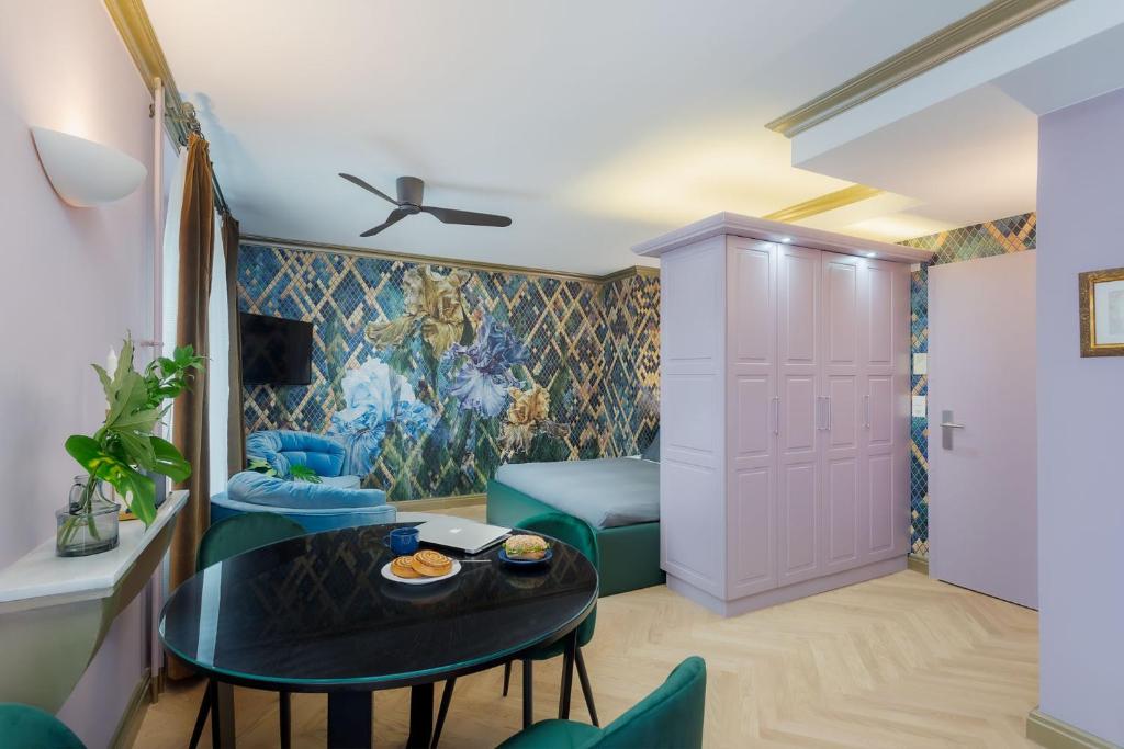 a living room with a table and blue chairs at VISIONAPARTMENTS Albertstrasse - self check-in in Zurich