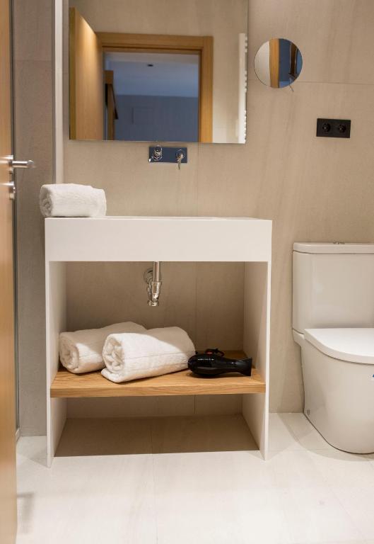 a bathroom with a sink and a toilet at Goodnight Cádiz Apartments in Cádiz