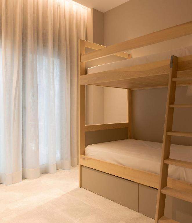a bedroom with bunk beds and a window at Goodnight Cádiz Apartments in Cádiz