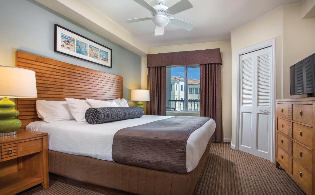 a bedroom with a large bed and a window at Club Wyndham Oceanside Pier Resort in Oceanside
