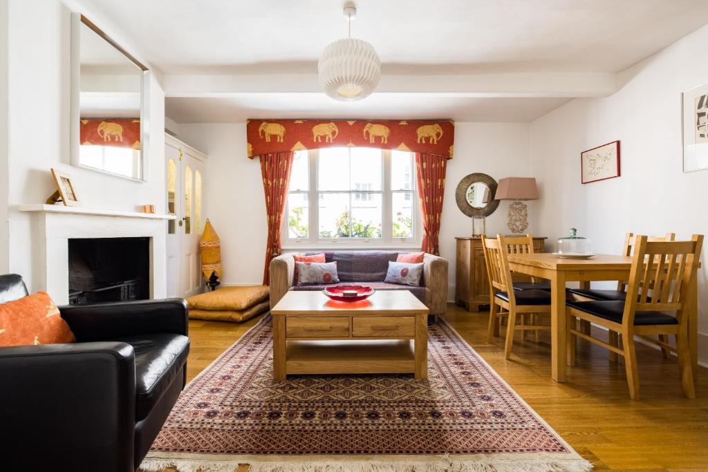 a living room with a couch and a table at Spacious, Light-Filled 2 Bedroom Apartment in London