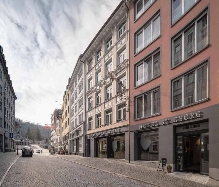 an empty street in a city with buildings at Boutique Hotel St. Georg in Einsiedeln