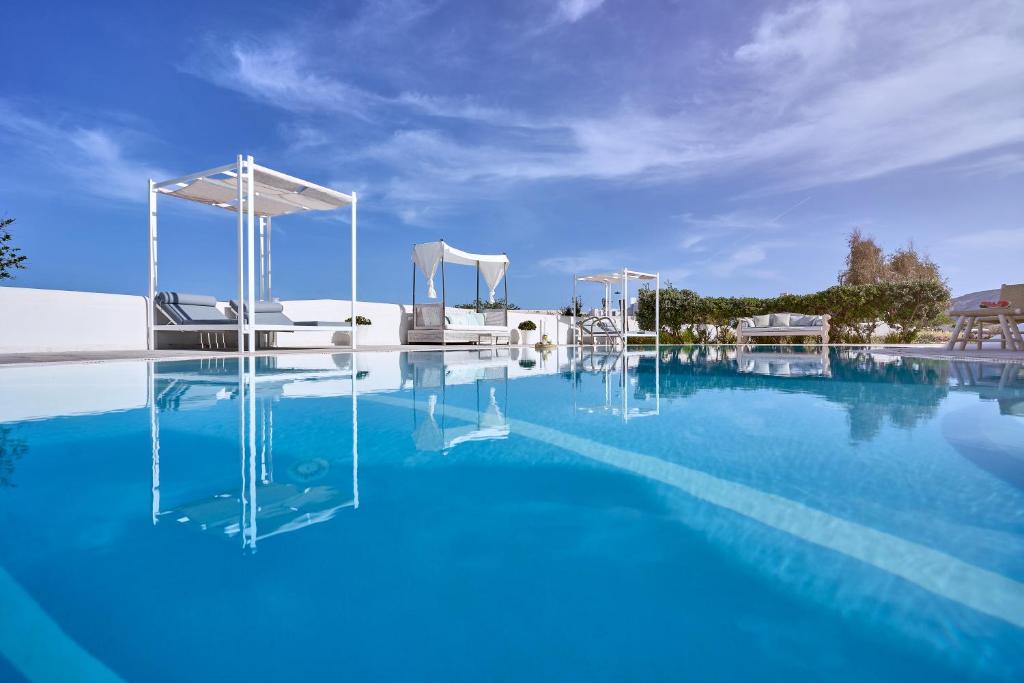 a large swimming pool with blue water at La Maison Private Villa in Agia Paraskevi