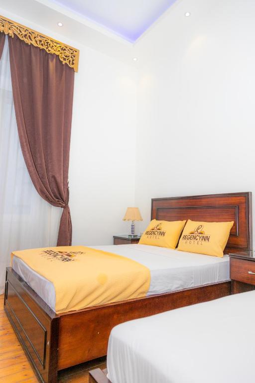 A bed or beds in a room at Regency inn