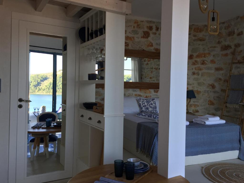 a bedroom with a bed and a table in a room at Oikies Skiathos in Skiathos