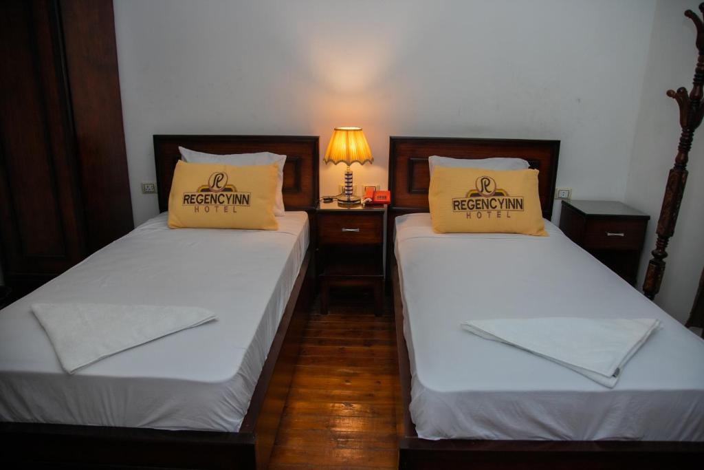 A bed or beds in a room at Regency inn