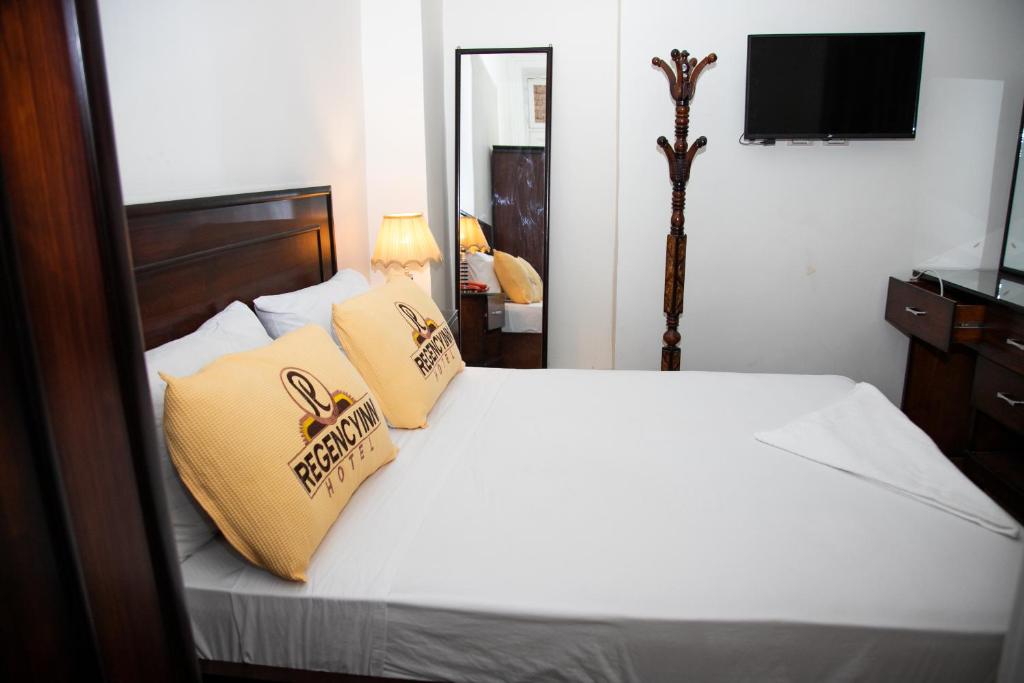 A bed or beds in a room at Regency inn