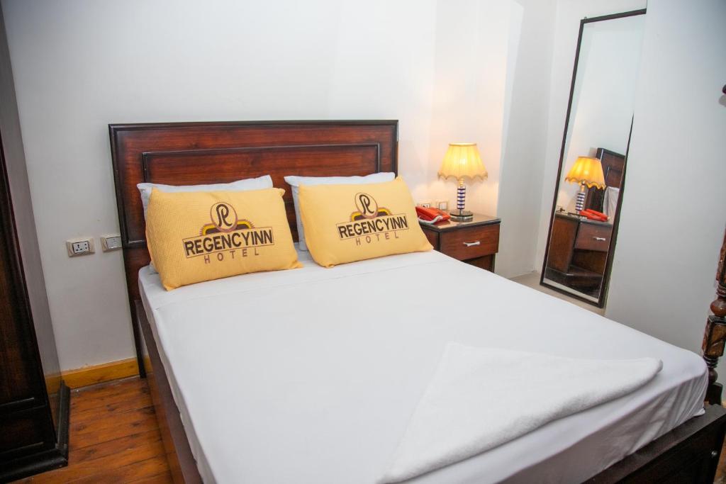 A bed or beds in a room at Regency inn
