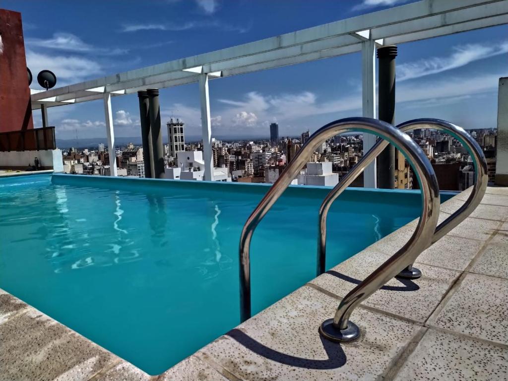 a swimming pool on the roof of a building at Departamentos Illia By Lugar in Cordoba