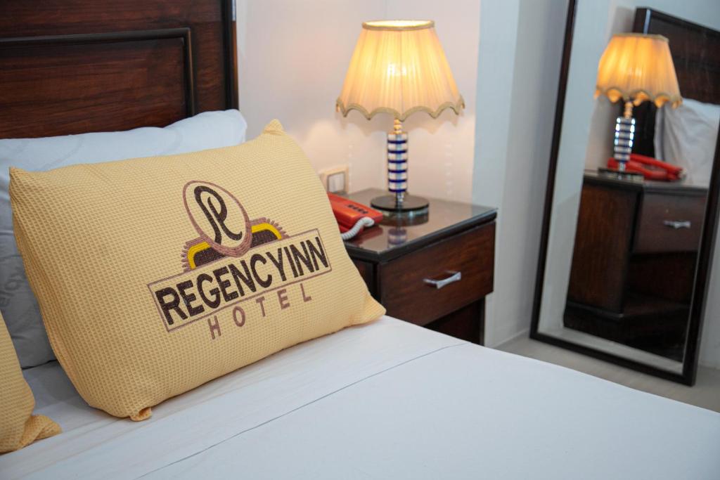 A bed or beds in a room at Regency inn