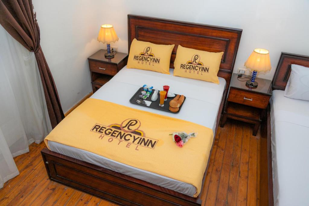 A bed or beds in a room at Regency inn