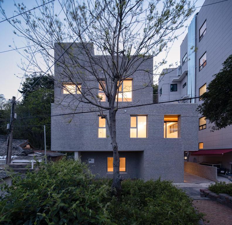 a building with a tree in front of it at Laon on 37 in Tongyeong