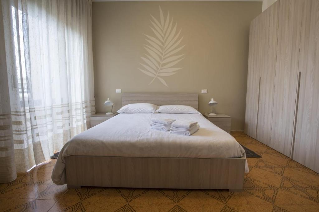 a bedroom with a bed with two towels on it at Mary Rose Apartment in Vicenza