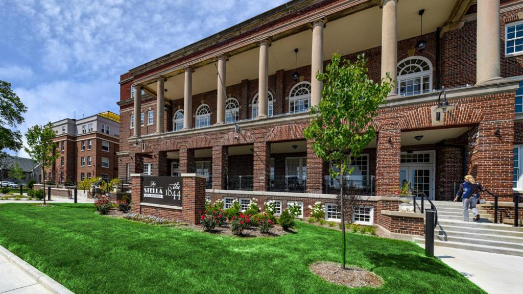 a brick building with a tree in front of it at The Stella Hotel & Ballroom in Kenosha