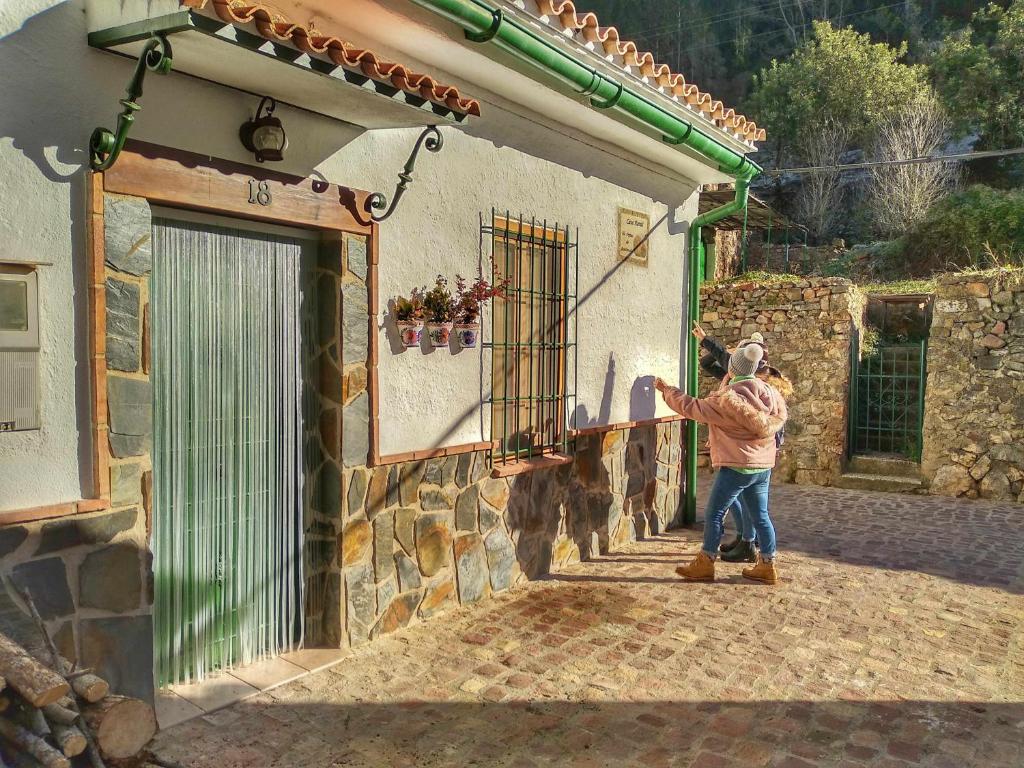 a young child is standing outside of a building at Els Orgues de Benitandús in Alcudia de Veo