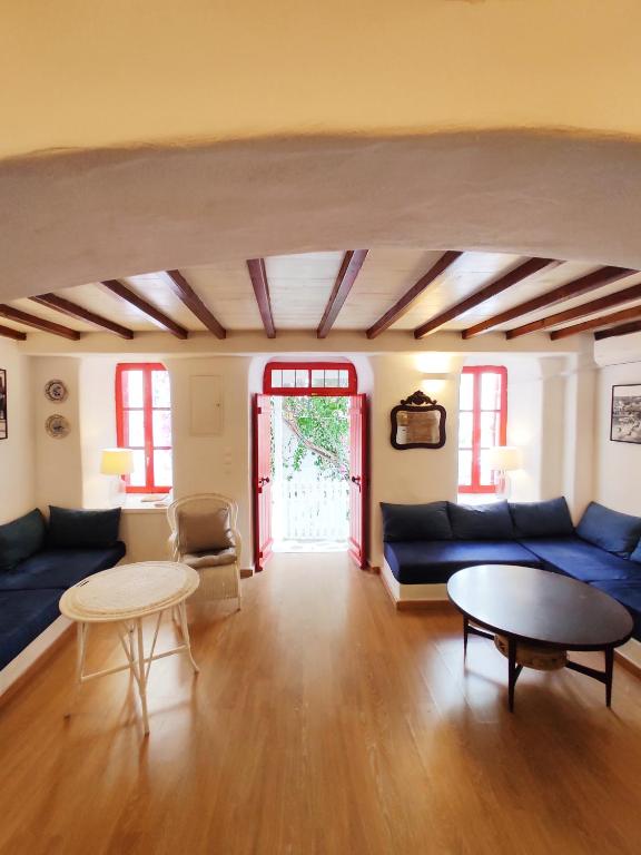 a living room with a blue couch and a table at Bougainvillea Typical Town House - Private Rooftop in Mikonos