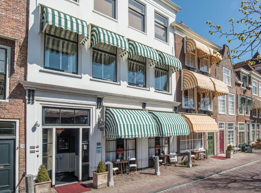 een gebouw met groene en witte luifels op een straat bij Boutique Hotel Huys van Leyden in Leiden