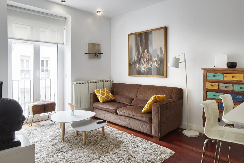 a living room with a couch and a table at Idiakez - Basque Stay in San Sebastián