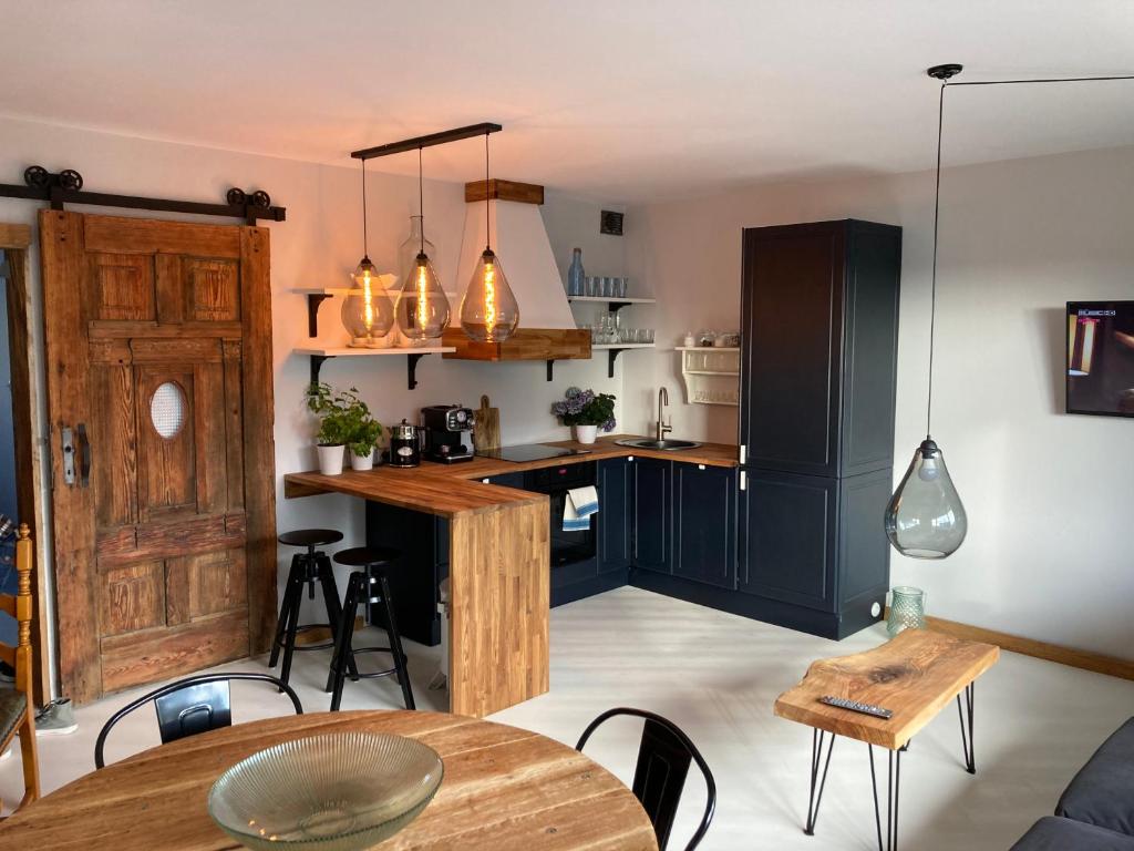 a kitchen and dining room with a table and chairs at Apartament Komorowskiego in Słupsk