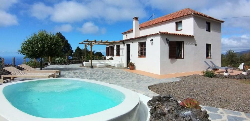 a villa with a swimming pool in front of a house at Finca Verode in Santa Cruz de Tenerife