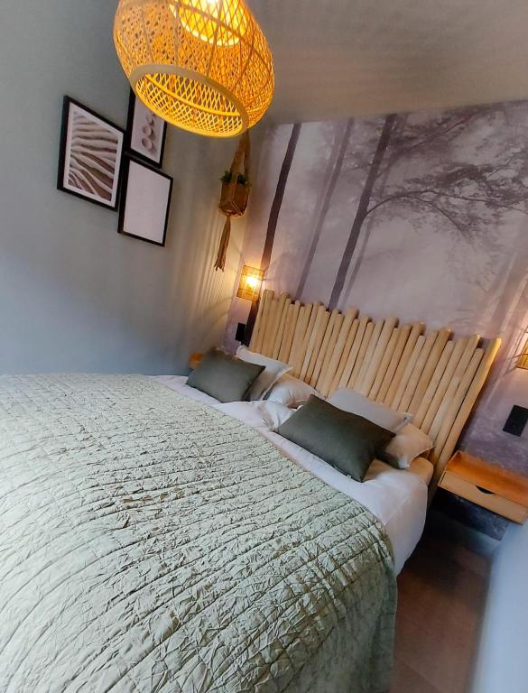 a bedroom with two beds and a chandelier at Snurk Texel in Den Burg