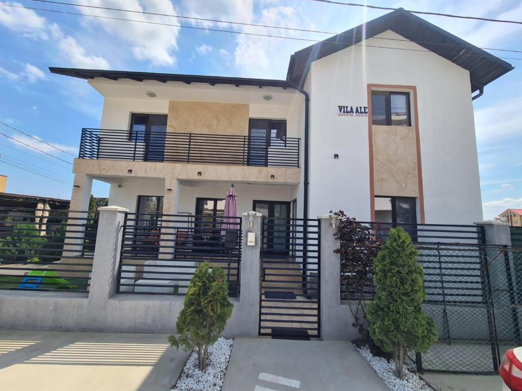 a white house with stairs and a fence at Vila Ale in Mamaia Sat/Năvodari