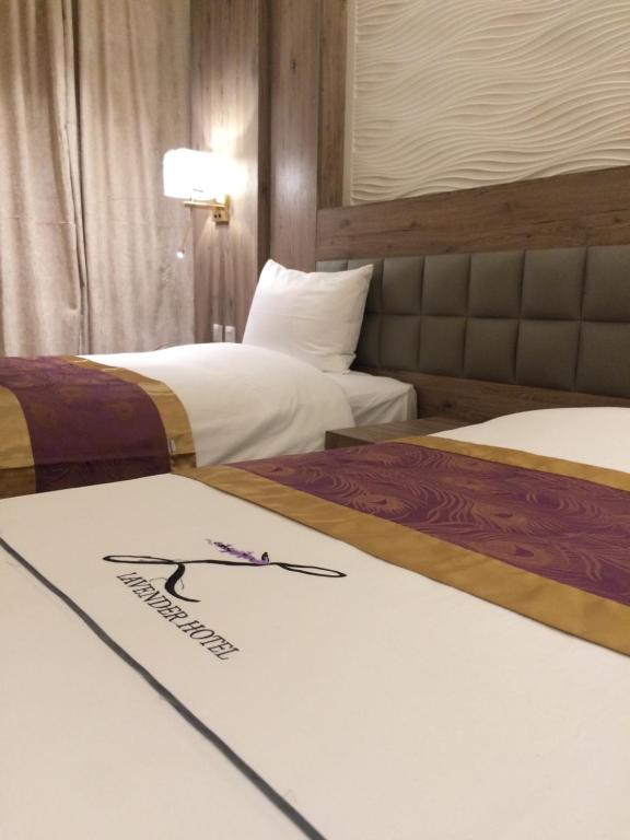 Postel nebo postele na pokoji v ubytování Lavender Serviced Apartments