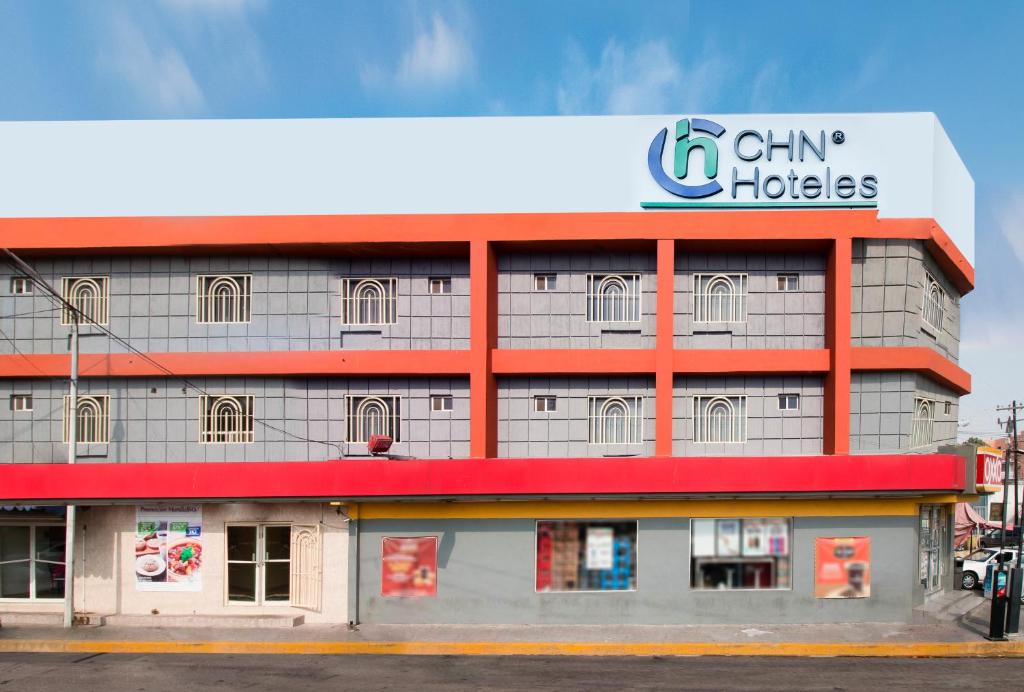 a building with a sign on top of it at CHN Hotel Monterrey Santa Fe in Monterrey