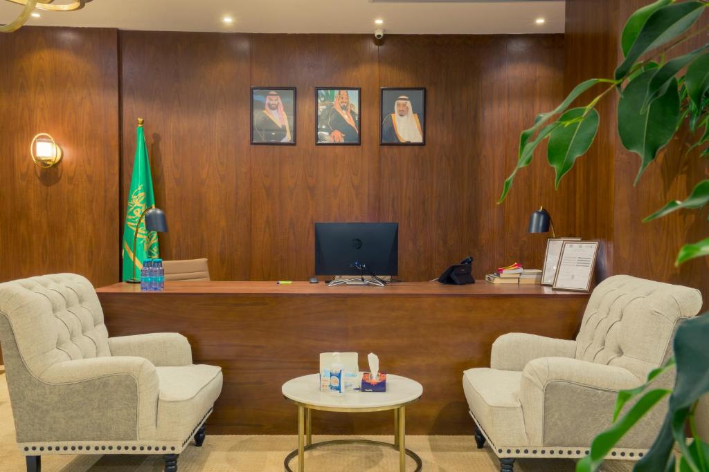 a waiting room with two chairs and a desk at 92 - وحدات فندقية - in Unayzah