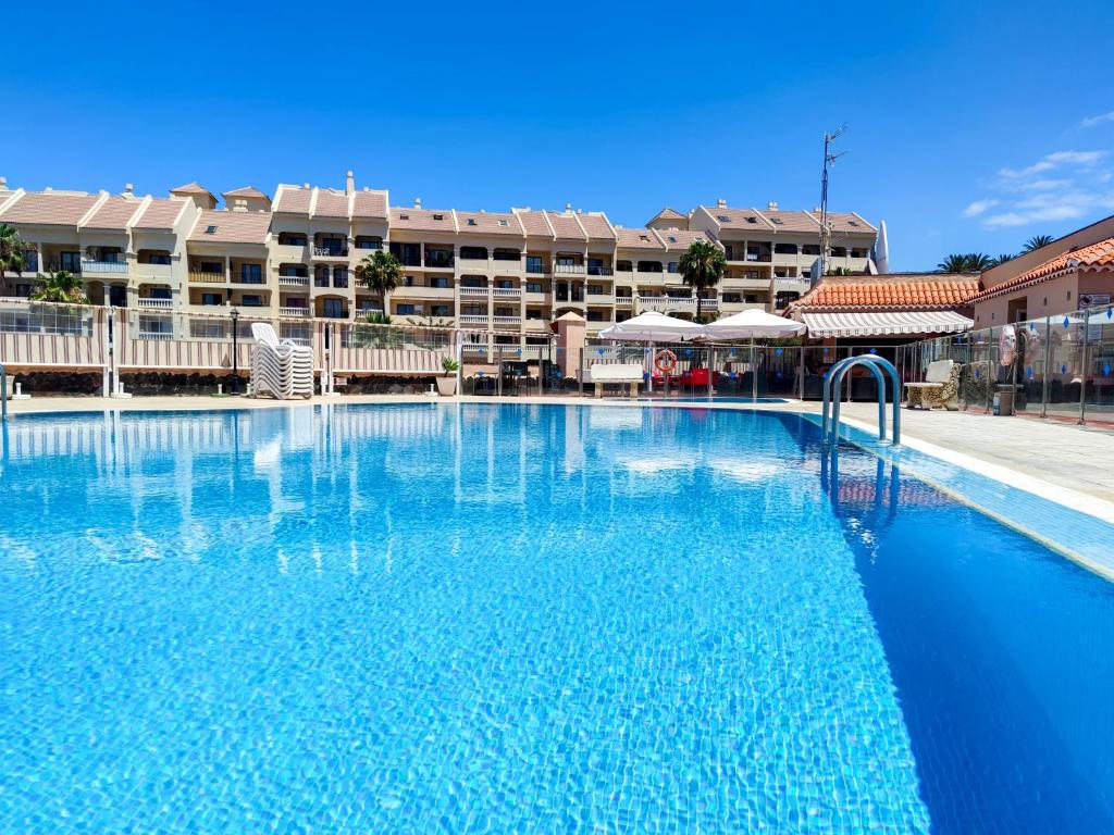 a large blue swimming pool in a hotel at Los Cristianos - heated swimming pool air-conditioned in Los Cristianos