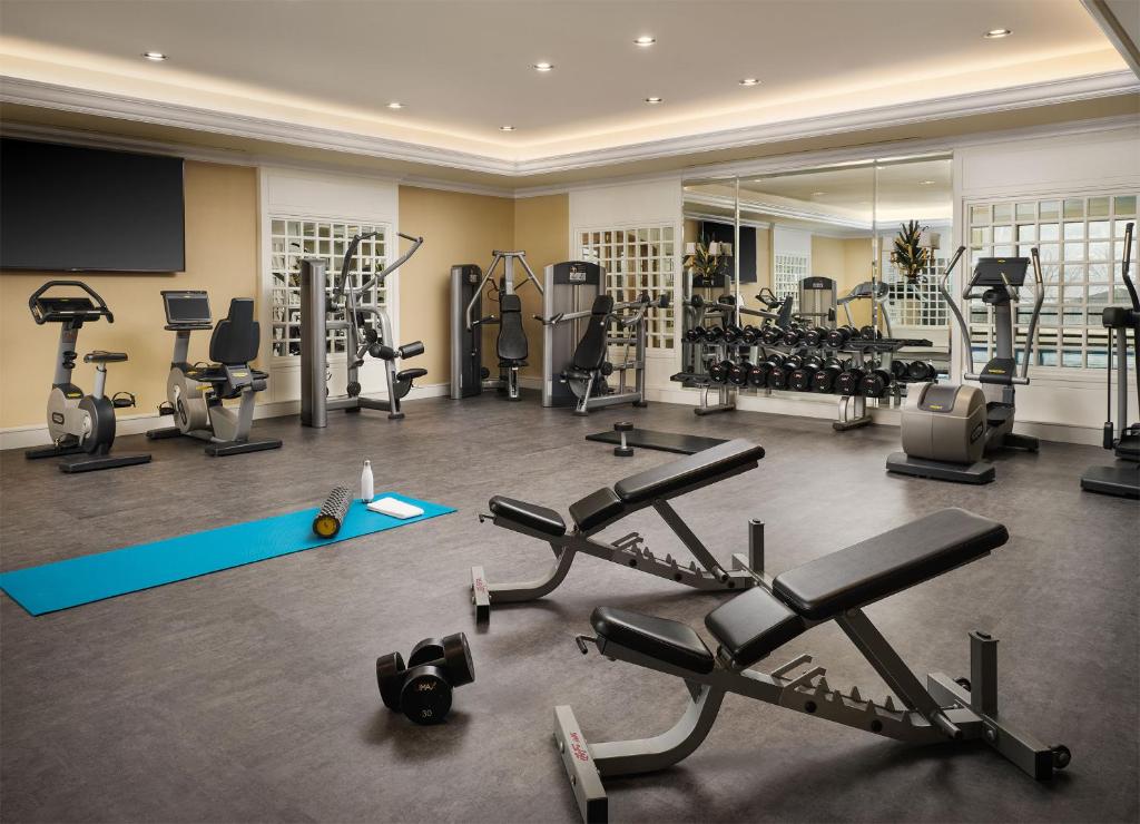 a gym with several treadmills and exercise machines at Little America Hotel Salt Lake City in Salt Lake City