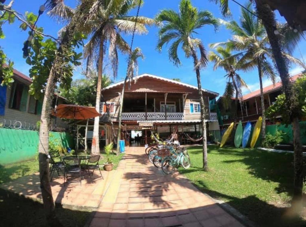 a house with palm trees and bikes parked in front of it at Spanish by the Sea - Bocas in Bocas Town