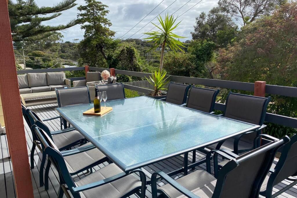 a glass table and chairs on a patio with a view at The Tea Trees Retreat in Rye in Rye