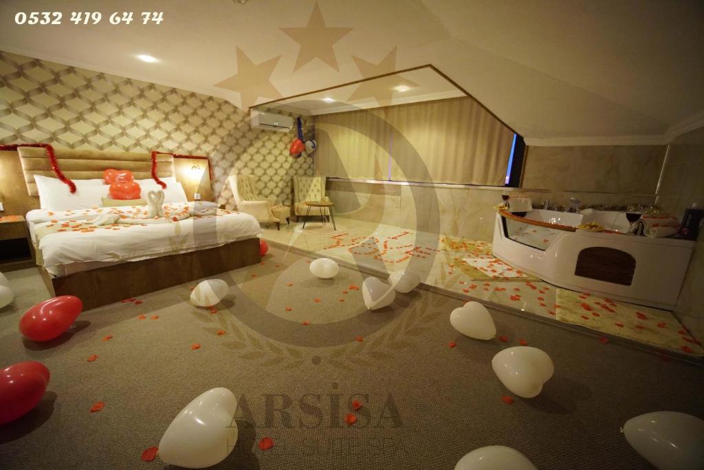 een slaapkamer met een bed en ballonnen op de vloer bij ARSİSA HOTEL SUİTE SPA in Avcılar