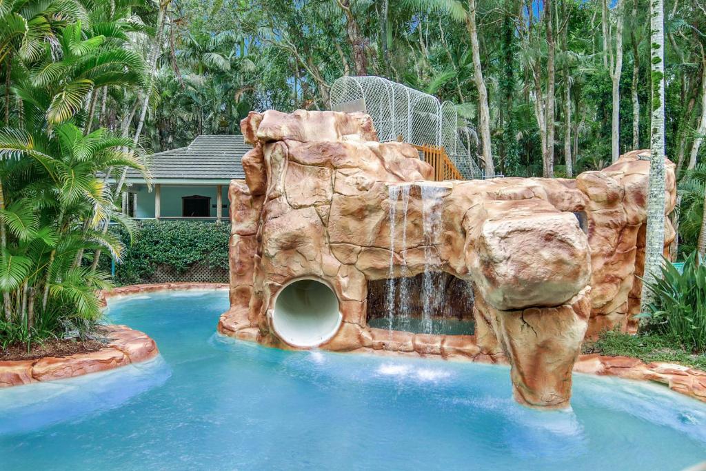 a water slide in a pool in a backyard at Villa 3 By The Sea in Coffs Harbour