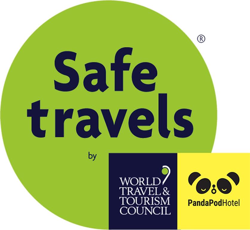 a green circle with the words safe travels on it at Panda Pod Hotel in Richmond