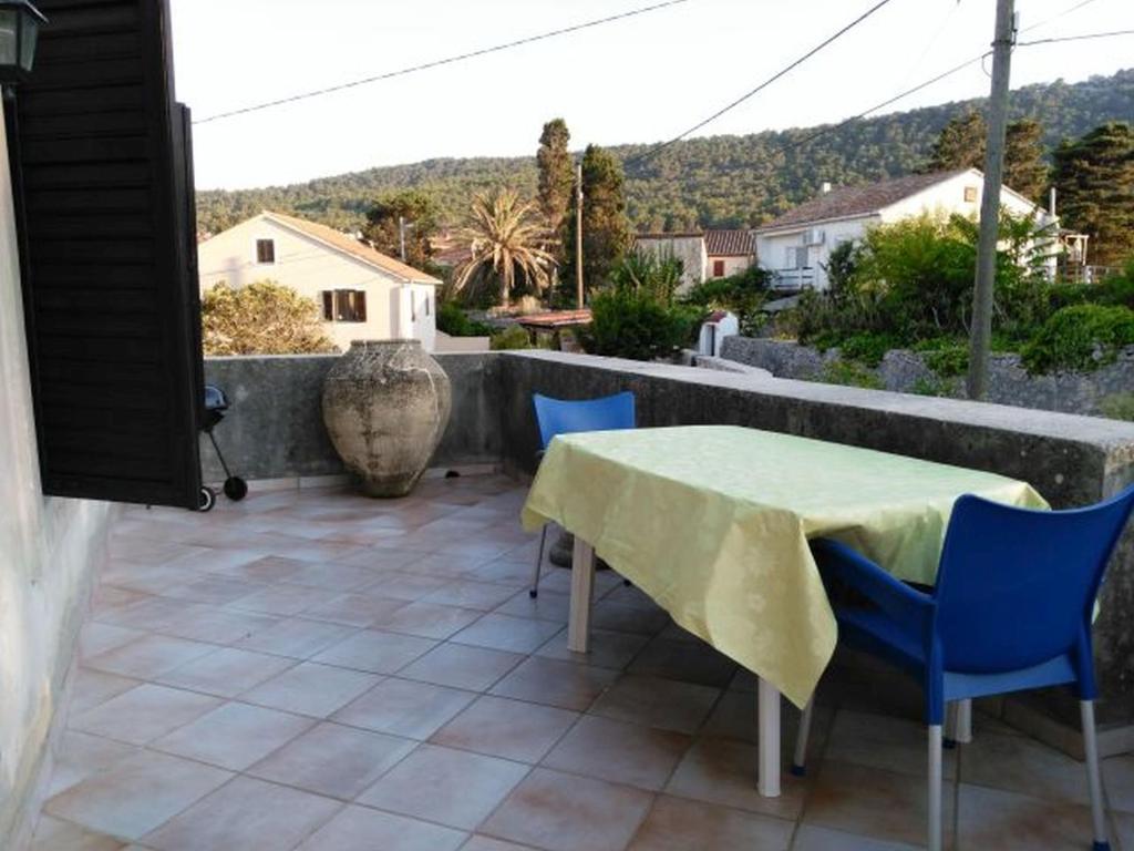 a table and chairs on a patio with a view at Apartment Everina in Veli Lošinj