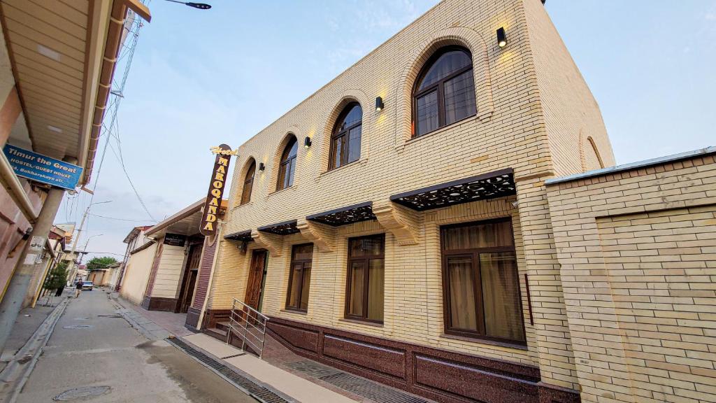 a large brick building on a city street at Hotel Maroqanda in Samarkand