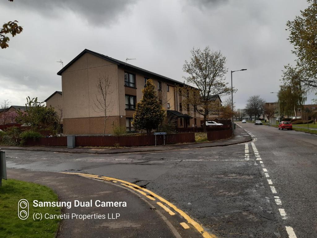 an empty street with a building on the corner at Carvetii - Stuart House - 1st floor flat sleeps up to 8 in Falkirk