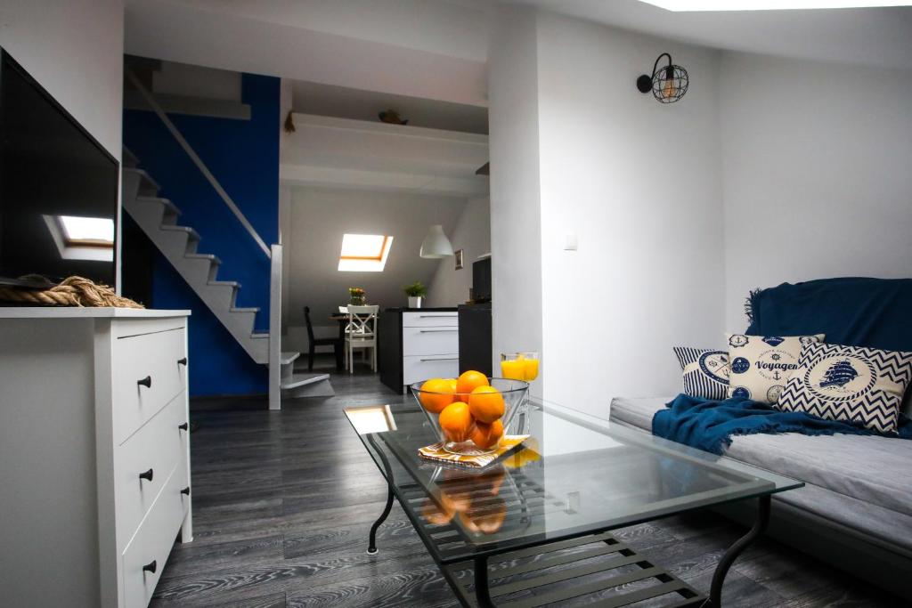 a living room with a couch and a glass table at Hugo in Władysławowo