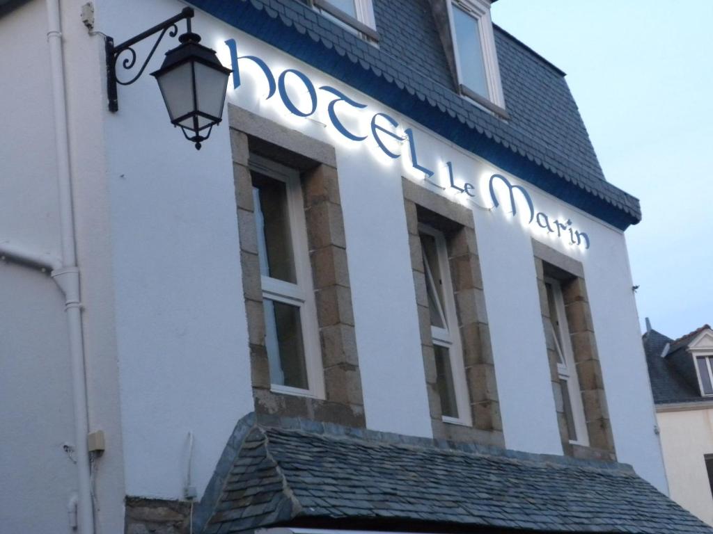 a building with a sign on the side of it at Hotel Le Marin in Auray