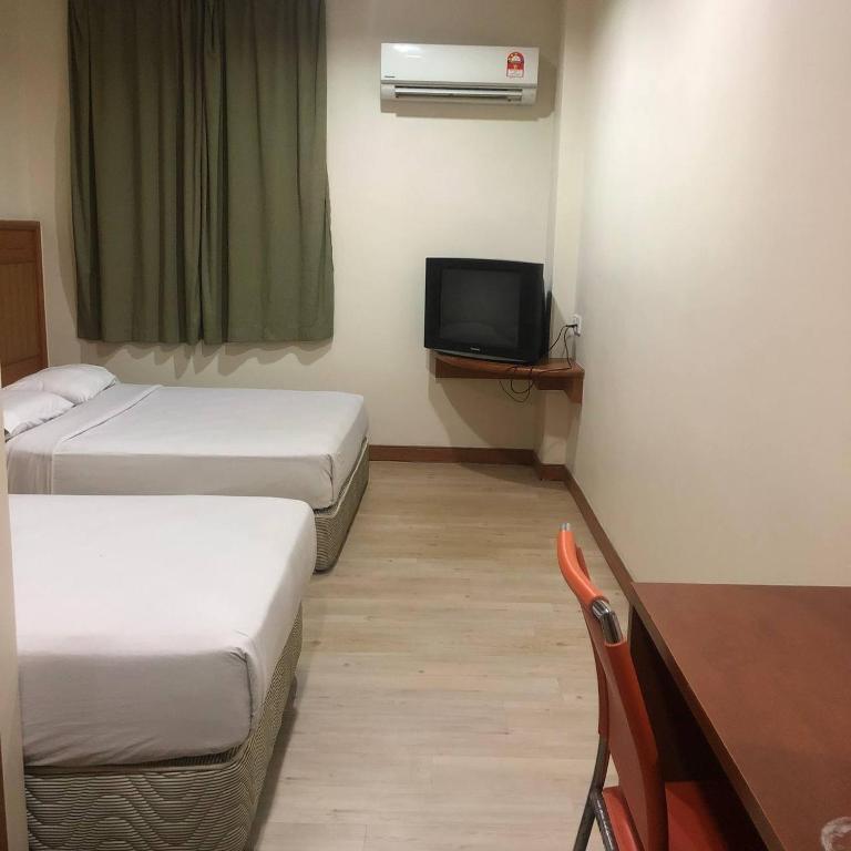 Postel nebo postele na pokoji v ubytování New Grand Hotel